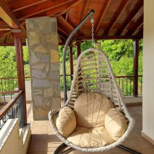 una veranda con sedia a dondolo su una terrazza di Villa Megara; Havuzlu Müstakil Villa a Kandıra