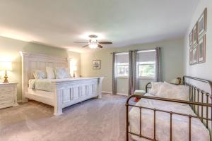 a bedroom with a bed and a ceiling fan at Contemporary Lakeside Haven with Dock and Hot Tub in Camdenton