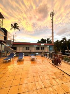 a large patio with chairs and a lighthouse at Hotel Terraza Inn in Rincon de Guayabitos