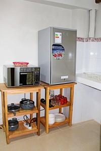 a kitchen with a refrigerator and a microwave at Central Plaza Apartments in Cusco