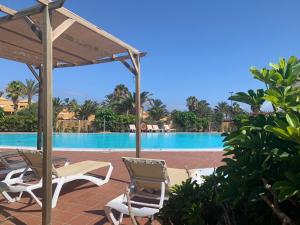 a view of the pool at a resort at Bedroom with shared bathroom and swimming pool in Corralejo +5 photos