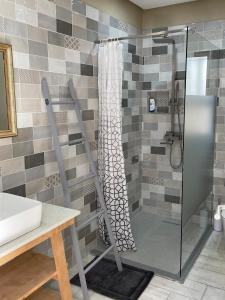 a shower with a glass door in a bathroom at Umdloti Villa in Umdloti