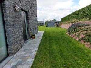 a walkway next to a brick building with a yard at Bed&Breakfast Durbuy in Durbuy