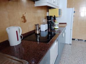 a kitchen with a counter top with a coffee maker at Dailos' Home in Puerto de Mogán