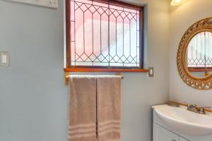 a bathroom with a sink and a window and towels at Cozy Santa Fe Getaway - Near Creek and Casinos in Pojoaque