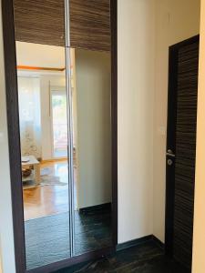 a glass door leading into a room with a hallway at Milion in Tivat