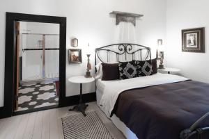 a bedroom with a bed and a mirror at Beard and Lady Inn in Chester