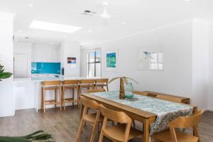 a kitchen and dining room with a table and chairs at Seascape Christies Ocean Views in Christies Beach