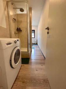 uma lavandaria com uma máquina de lavar roupa e um corredor em Kartels First Appart em Kierspe