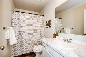 a bathroom with a sink and a toilet and a shower at BRAND NEW 4-BDRM HOME Farmhouse at Grand Rapids in Meridian +21 photos