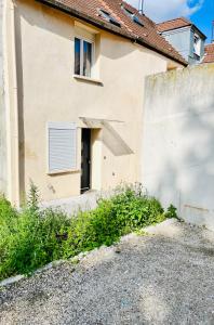 a building with a door and a window at Tiny house 4 min drive to Cdg airport in Roissy-en-France