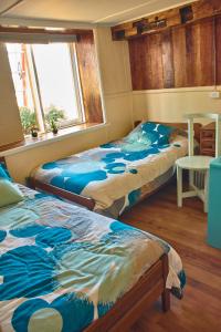 Postel nebo postele na pokoji v ubytování Hostal Triwe