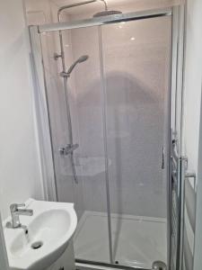 a bathroom with a shower and a sink at 5 bedroom house - Cheshire Oaks in Ellesmere Port