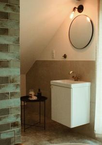 a bathroom with a sink and a mirror on the wall at FORREST in Polanica-Zdrój