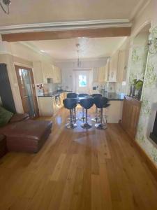 a living room with a table and chairs in a kitchen at 5 min walk to Beaches & Pembrokeshire Coast Path in Pembrokeshire