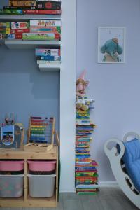 a childs room with a shelf of books and a desk at Family Apartment - Centrum in Kudowa-Zdrój