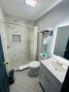uma casa de banho com um WC branco e um lavatório. em Hillsboro Inn & Suites em Hillsboro