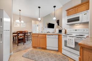 a kitchen with white appliances and a dining room at Near Tamarack AC Kitchen TV Washer Dryer in Donnelly