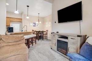 a living room with a fireplace and a tv on the wall at Near Tamarack AC Kitchen TV Washer Dryer in Donnelly