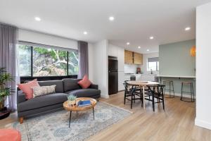 a living room with a couch and a table at Mint at Sea Mist - Boho Haven Near West Beach in Henley Beach South