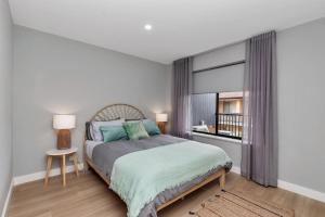 a bedroom with a bed and a window at Mint at Sea Mist West Beach in Henley Beach South