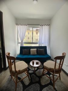 馬尼薩萊斯的住宿－apartamento ubicado parte histórica de manizales，客厅配有蓝色的沙发和两把椅子