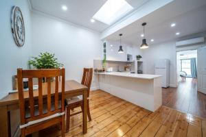 a kitchen and dining room with a table and chairs at Plane Tree Cottage North Adelaide in Bowden