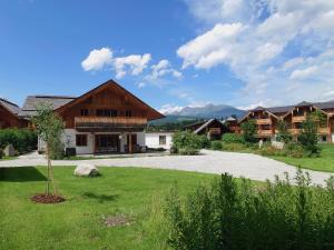 a resort yard with a pathway leading to a building at Premium Tauernstyle Golling in Mariapfarr