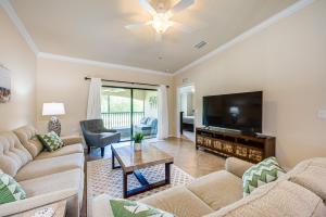 a living room with couches and a flat screen tv at Bonita Springs Condo Rental with 2 Screened Porches in Bonita Springs