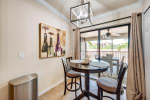 a dining room with a table and chairs at Bonita Springs Condo Rental with 2 Screened Porches in Bonita Springs