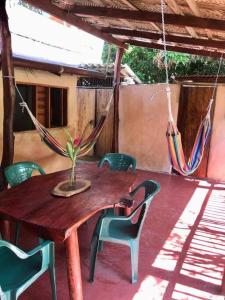 a wooden table and chairs on a porch at Caza Terraza in Palomino