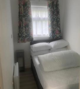 two beds in a room with a window at Ground floor apartment Brean in Brean