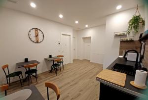 a kitchen and dining room with a clock on the wall at L'angolo di Luna in Gorizia