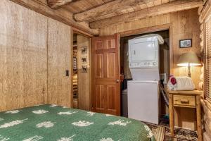 a kitchen with a refrigerator and a stove in a room at VERY private, real log cabin with hot tub! in Sevierville