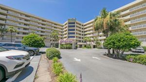 a parking lot in front of a large building at Inlet Reef 215 - Spacious condo with complimentary seasonal beach service and great water views in Destin