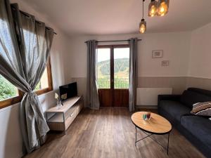 a living room with a couch and a table at Le Plaisance, Beuil Les Launes in Beuil