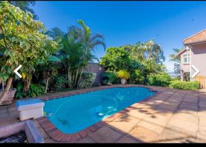 a swimming pool in the backyard of a house at Zopry's Guest House in Durban