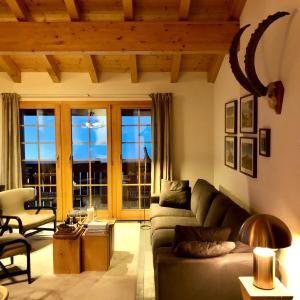 貝特默阿爾卑的住宿－Chalet Sirius Dachwohnung，客厅配有沙发和桌子