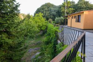 a balcony with a fence and trees and a building at Village of Peace - House 25 in Shkodër