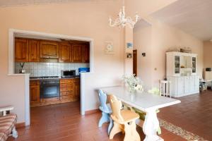 a kitchen with a white table in a room at La Gipsofila Attic in Osimo