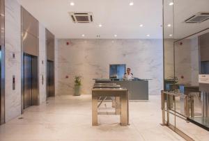 a man sitting at a desk in a lobby at Apartamento en Recoleta in Buenos Aires