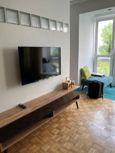a living room with a large flat screen tv on a wall at Apartament Powiśle in Warsaw