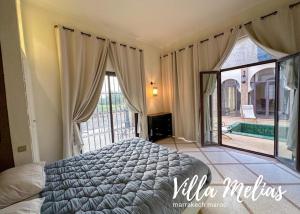 a bedroom with a bed and a large window at Villa Melias in Marrakesh