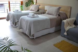 two beds with towels on them in a room at Inti. in Saladillo