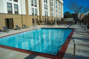 a large swimming pool in front of a building at Hampton Inn Beaumont in Beaumont