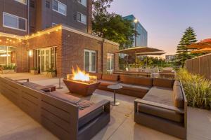 a patio with a fire pit and a building at Cambria Hotel LAX in El Segundo