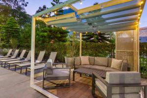 a row of chairs and a couch under a pergola at Cambria Hotel LAX in El Segundo