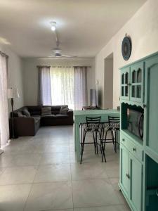 - un salon avec une table verte et un canapé dans l'établissement Amplio departamento con alberca, à Playa del Carmen