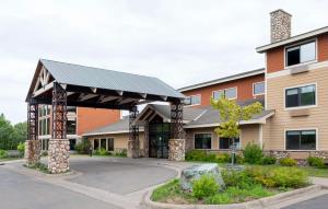 a building with a metal roof on a street at Black Beach Inn by GrandStay in Silver Bay