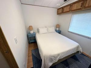 a small bedroom with a bed and a window at 15 min to Disney World, Self-check-in, Full Kitchen in Kissimmee
